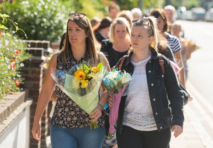 <strong>People arrive to leave flowers on Lennard Road in Penge.</strong>