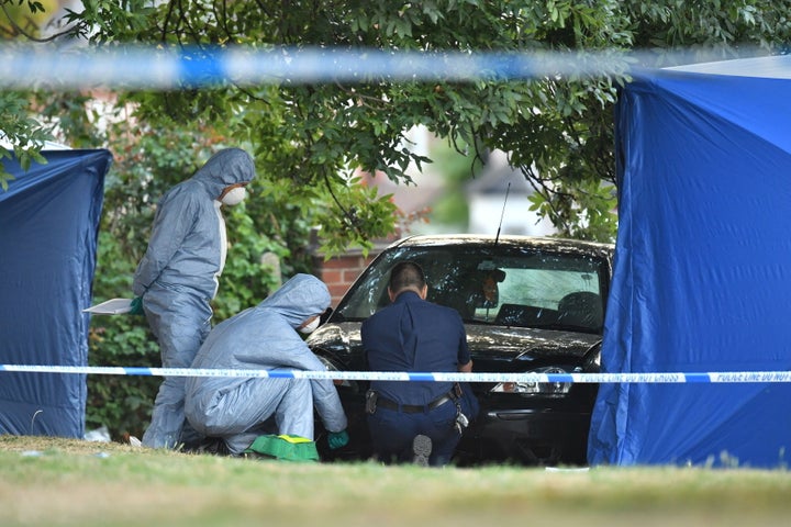<strong>Forensic police officers examine a car at the scene in Lennard Road.</strong>