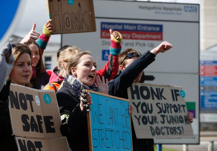 Demonstrators and Junior doctors hold placards as they protest outside the Basingstoke and North Hampshire Hospital