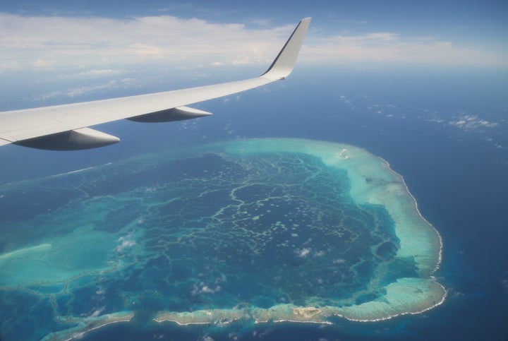 The view out the window of Air Force One, with President Barack Obama aboard, over a nearby island as the airplane approaches Midway Atoll in the Papahanaumokuakea Marine National Monument in the Pacific Ocean, September 1, 2016.