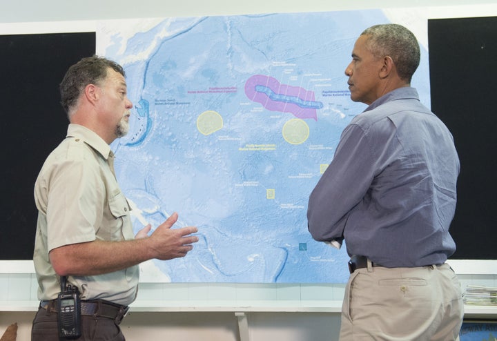 President Barack Obama, alongside refuge manager Bob Peyton, looks at a map of Midway Atoll in the Papahanaumokuakea Marine National Monument in the Pacific Ocean, September 1, 2016.