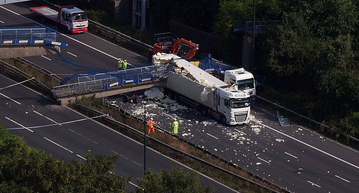 The scene on the M20 after a lorry hit a motorway footbridge, causing it to collapse last Bank Holiday weekend.