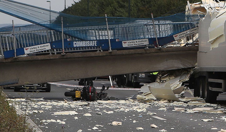 A motorcycle lies on the ground under thecollapsed bridge on the M20. The rider told how he feels lucky after coming off his bike to escape serious injury when the bridge collapsed in front of him.