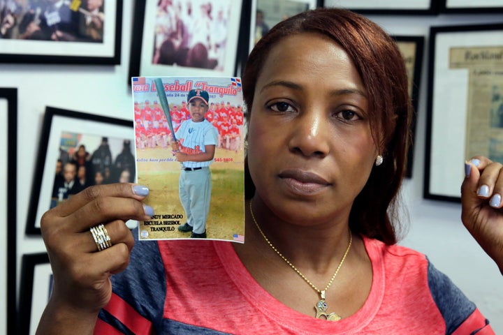 Maribel Martinez holds a photo of her son Andy at her attorney's office.