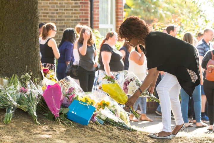 People lay flowers Lennard Road in Penge, south-east London.