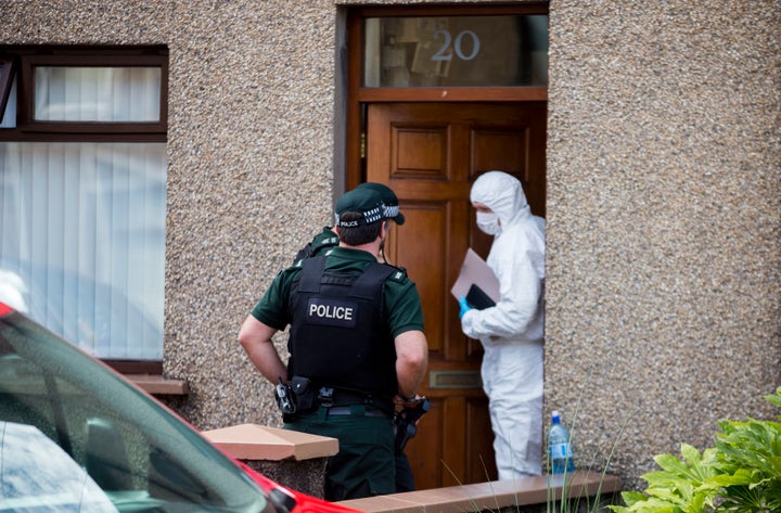 Police and army technical officers searching properties on Old Glenarm Road in Larne, Co Antrim.