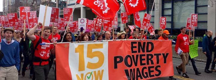 Activists march in support of raising the federal minimum wage to $15 per hour.