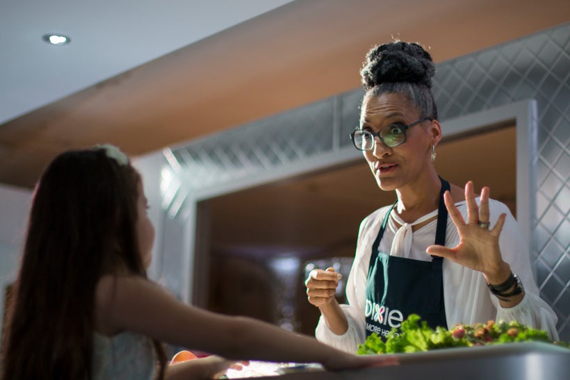 Carla Hall gives a Deadzone Diner guest a taste of one of the event's signature dishes.