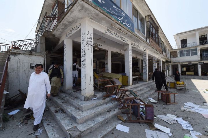 Pakistani security officials inspect the site of a suicide bomb attack at a district court in Mardan on September 2, 2016.