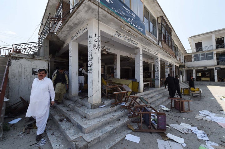 Pakistani security officials inspect the site of a suicide bomb attack at a district court in Mardan on September 2, 2016.