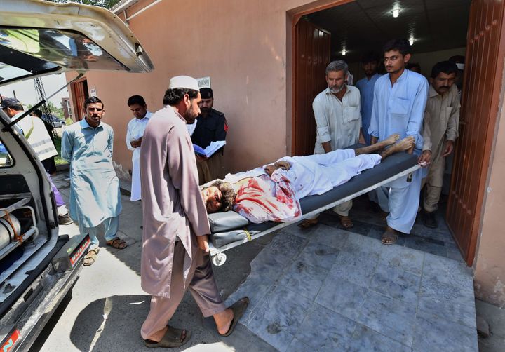 Pakistani volunteers transport an injured blast victim at a hospital following a suicide bomb attack at a district court in Mardan on September 2, 2016.