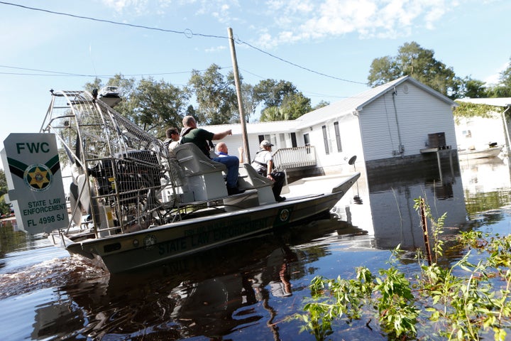 Law enforcement officers use an airboat to survey damage around homes from high winds and storm surge associated with Hurricane Hermine which made landfall overnight in the area on September 2, 2016 in St. Marks, Florida.