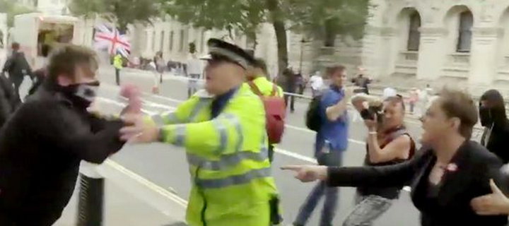 The moment Izzard, right, has his beret stolen at March for Europe