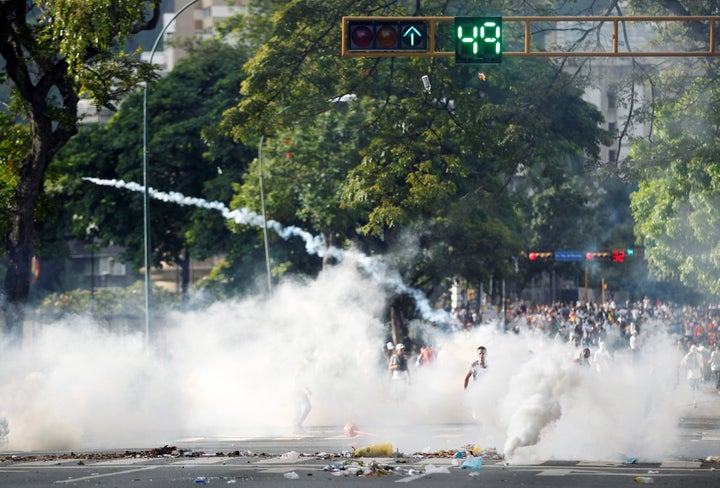Protesters clash with the police during a rally to demand for a referendum to remove Venezuela's President Nicolas Maduro in