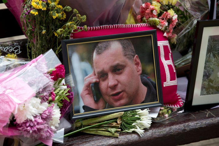 Floral tributes and a photograph of Arek Jozwik were placed on a bench at the scene where he was attacked