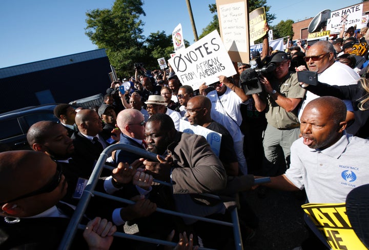 Protesters try to enter the property of Great Faith Ministries in Detroit before a visit by Republican presidential nominee Donald Trump on Sept. 3 in Detroit.