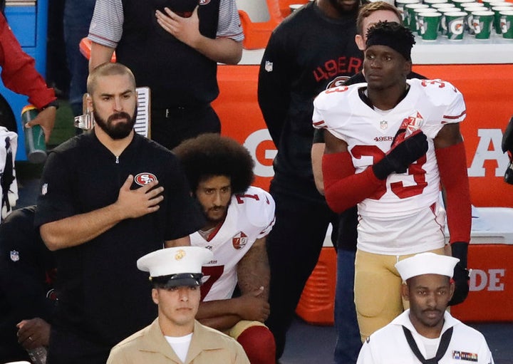 Quarterback Colin Kaepernick of the San Francisco 49ers taking a stand by taking a knee during national anthem. 