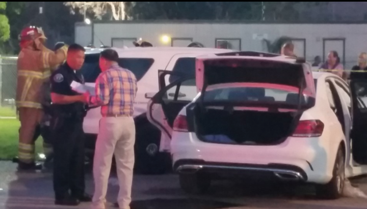 Police investigate the scene of a crash outside Irvine Meadows Amphitheatre.