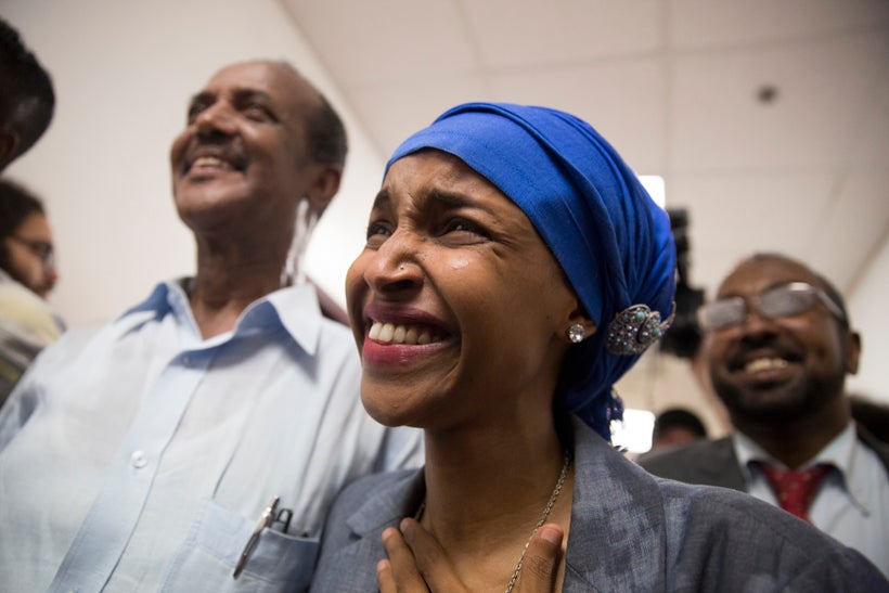 Ilhan Omar walks down the hall ecstatic about her victory over Phyllis Kahn and Mohamud Noor to the watch party for her campa