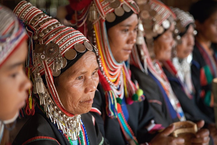 Akha women performing a traditional Akha dance; northern Thailand near Chiang Rai.