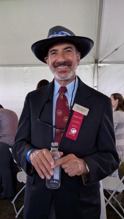 Hampton Classic Communications Officer Martin Bauman wears fancy fedoras