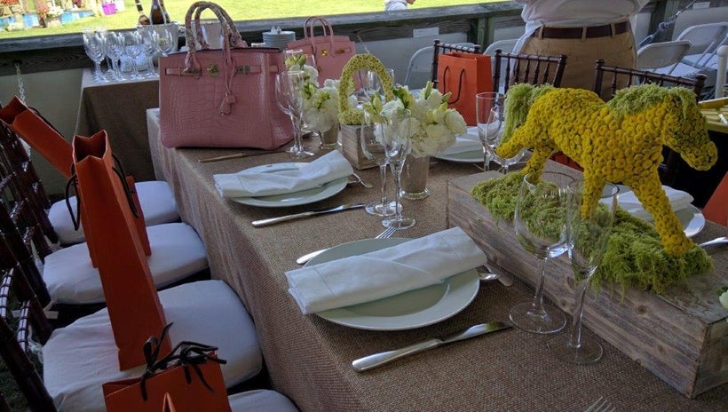 Table by Hermes featured Birkin bags and bright orange shopping bags