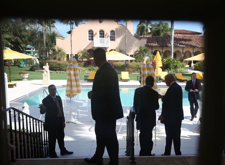 Donald Trump chats with Ben Carson at the Mar-a-Lago Club in March. The GOP nominee has spent his campaign's money on his own properties rather than cheaper alternatives nearby.