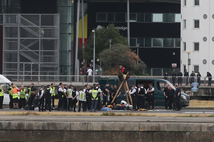Emergency services surround protestors from the movement Black Lives Matter after they locked themselves to a tripod on the r