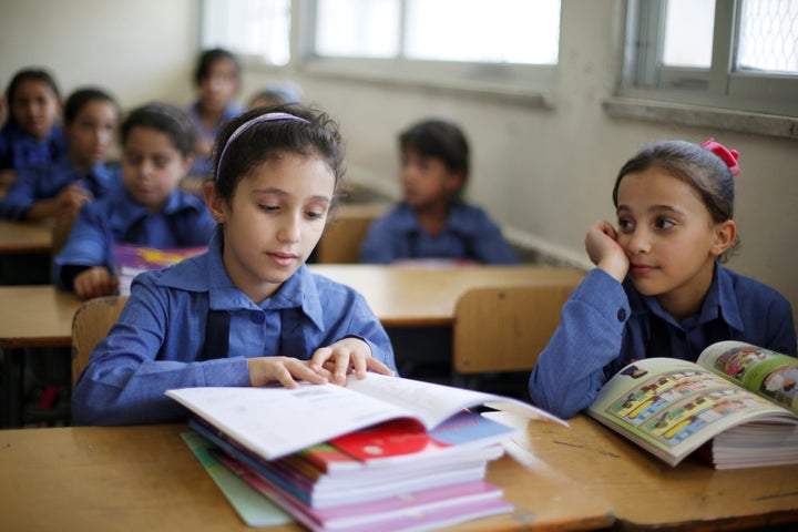 Refugee schoolchildren receive their new books on the first day of the new school year at one of the UNRWA schools at a Palestinian refugee camp al Wehdat, in Amman, Jordan, September 1, 2016. REUTERS/Muhammad Hamed