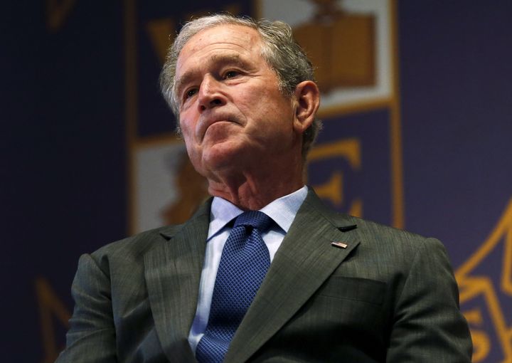 Former U.S. President George W. Bush listens to a speech while visiting Warren Easton Charter High School one day before the ten year anniversary of Hurricane Katrina in New Orleans, Louisiana, August 28, 2015.