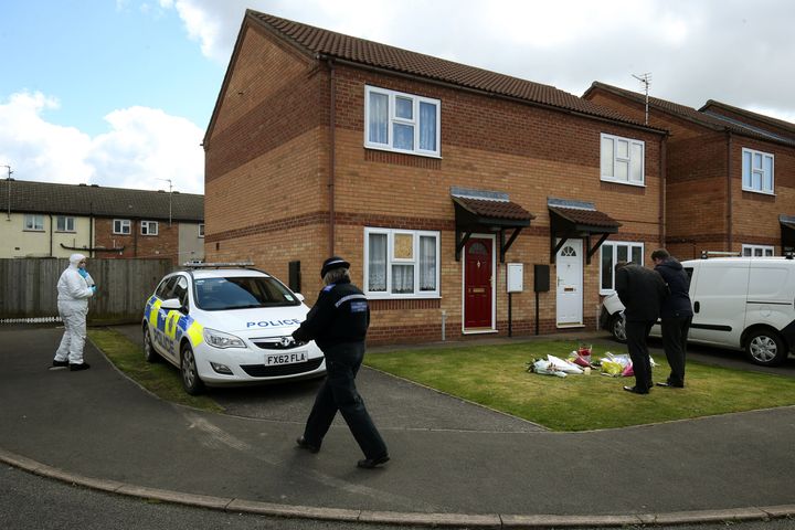 <strong>Police outside the home where the pair were found dead in April</strong>