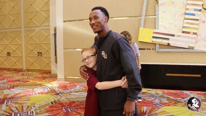 FSU football player Travis Rudolph is seen embracing Bo Paske during their emotional reunion on Sunday.