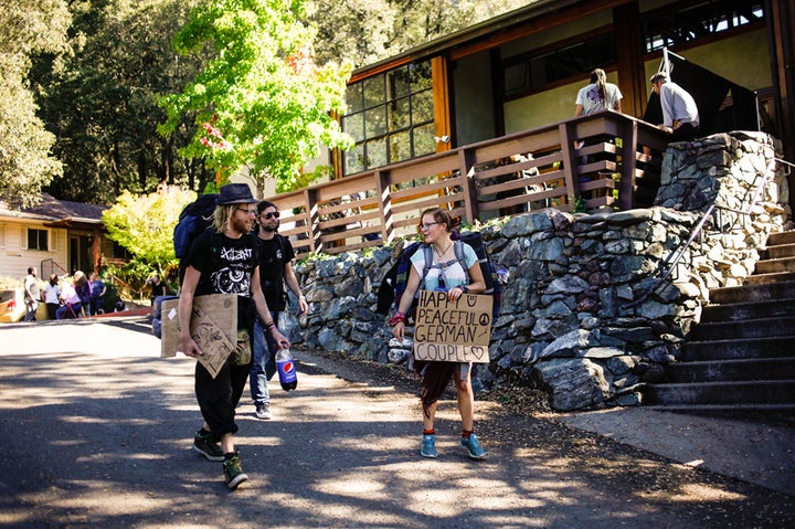 Carsten (left) and girlfriend Maya (right), both of Germany, and Beaver (back) of London head out after a free lunch at the Mateel Community Center in Redway, Calif. They were looking for trimming jobs to fund their travels but hadn’t gotten any work yet.