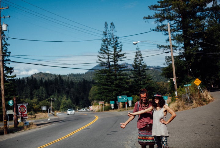 Khaled Mourra (left) of Mexico and Mayssan Charafeddine of Montreal try to hitch a ride in Garberville, Calif. During harvest season, “trimmigrants” crowd the town’s sidewalks jockeying for jobs with homemade signs or try to meet potential employers by frequenting local bars.