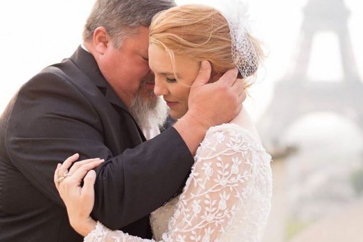 In this 2015 photo, Tim Buchanan is seen hugging his wife, Jeni, in Paris. Buchanan died of a heart attack on Sept. 3 at his daughter's wedding right after the father-daughter dance.