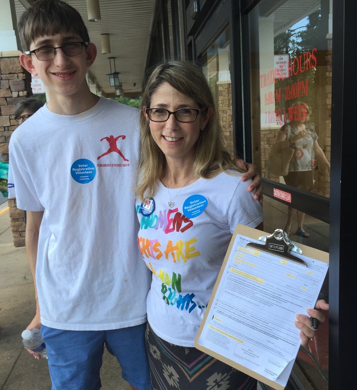 <i>The author and her 16-year-old son registering voters in Virginia.</i>