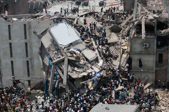 People rescue garment workers trapped under rubble at the Rana Plaza building after it collapsed April 24, 2013.