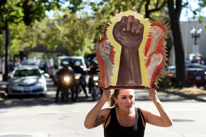 A protester holds a sign during a Black Lives Matter protest in Oakland, California.