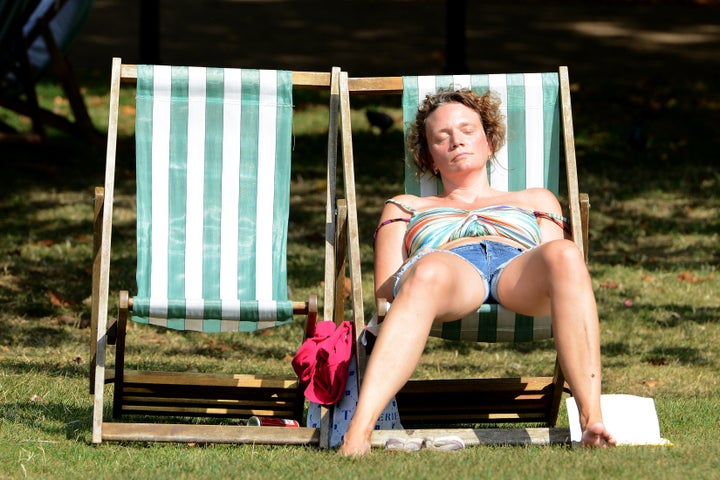 (Above and below) People in Green Park, London enjoy the hot weather on Wednesday