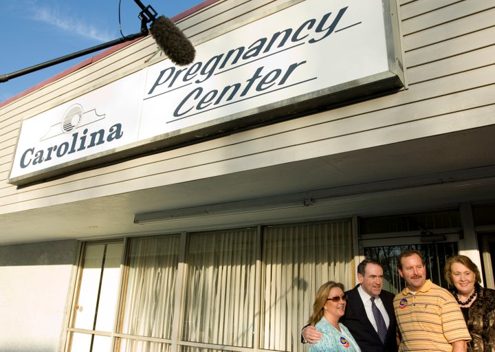 Former presidential candidate and vocal anti-abortion politician Mike Huckabee poses outside of a South Carolina CPC in 2008. 