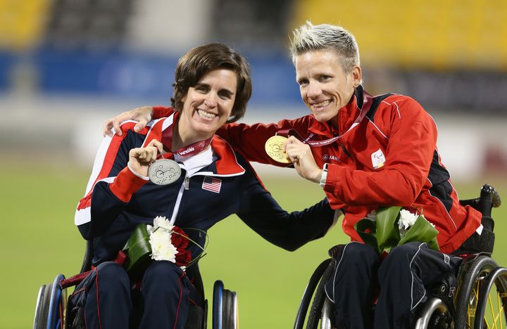 Marieke Vervoort of Belgium (right) celebrates her gold with Kerry Morgan of USA (left) and her silver in the women's 400m T52 final during the Evening Session on Day Ten of the IPC Athletics World Championships at Suhaim Bin Hamad Stadium on October 31, 2015 in Doha, Qatar.