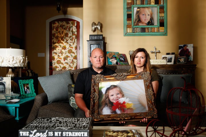 Kelly and Ryan Breaux sit holding a portrait of their deceased daughter Emma Breaux in their home in Breaux Bridge, Louisiana, on June 16, 2016. The husband and wife lost twins, Emma and Talon, to different superbugs that they contracted while in the neonatal unit at Lafayette General Hospital. U.S. Picture taken June 16, 2016.