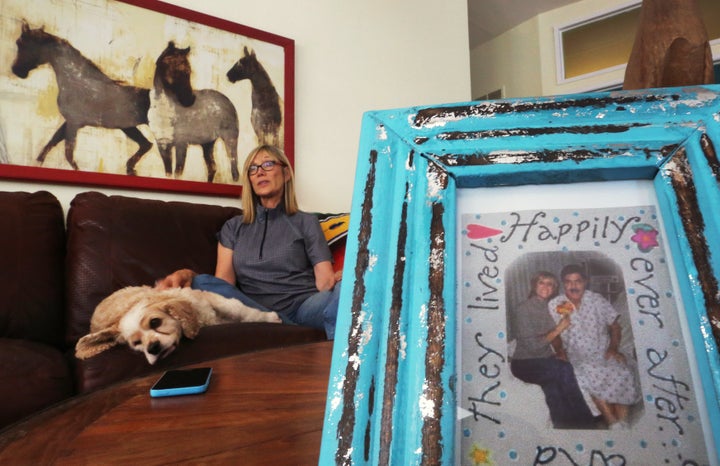 Rae Greulich, whose husband Dan died from an antibiotic resistant infection, speaks to a reporter near a photo taken on their wedding day in Agoura Hills, California, U.S. on June 27, 2016.