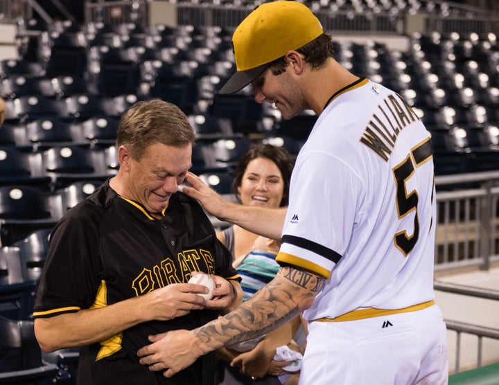 Trevor Williams' teary-eyed father, Richard Williams, is seen holding Wednesday's game ball as he celebrates with the Pirates