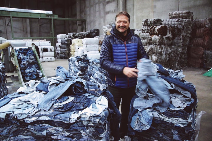 Bert van Son, CEO of Mud Jeans holding a pair of recycled denim.