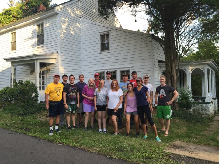 Anne (fifth from left) wth the volunteer crew in front of the renovated house.