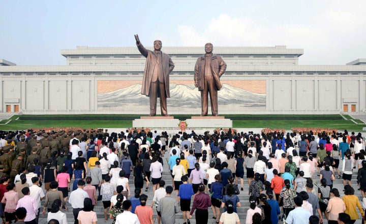 Service personnel and civilians lay floral baskets, bouquets and flowers before the statues of President Kim Il Sung and leader Kim Jong Il on the 68th founding anniversary of the DPRK in this undated photo released by North Korea's Korean Central News Agency (KCNA) September 9, 2016.