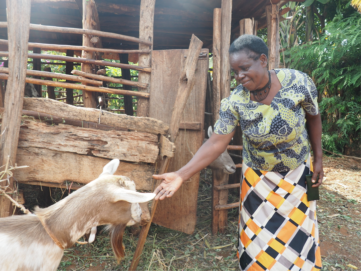 Magdalene with one of the goats she purchased with her Project Nurture income 