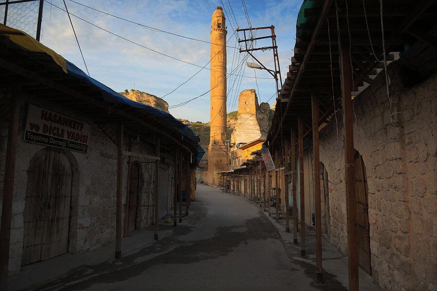 Hasankeyf's main street at sunrise. In the past, many restaurants, souvenir shops and small hotels were open to tourists. In 2010, the government permanently closed many of the ancient monuments, ruins and caves after someone was killed by a falling rock.