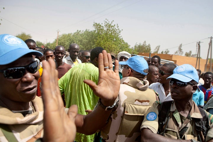 United Nations peacekeepers try to calm a crowd during a protest against sending peacekeepers from Senegal to the northern rebel-held town of Kidal before sending Malian soldiers there, in Gao July 5, 2013.